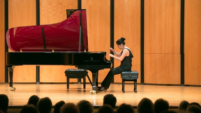 Kristina Cheng plays a maroon inlaid Steinway in the Ruth Taylor Recital Hall
