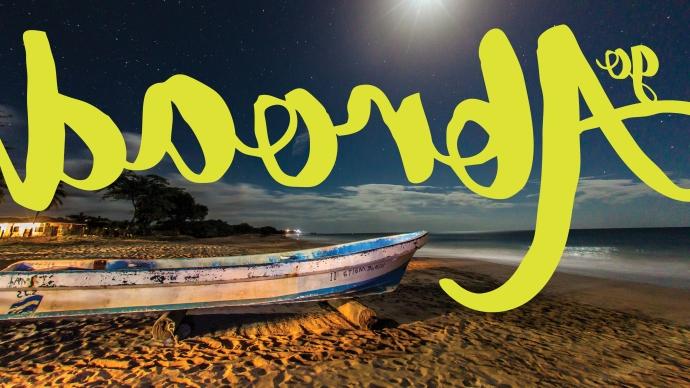 a beach and a boat at night in Nicaragua, with "Go Abroad" written on top