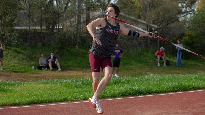 ian blount mid-throw of a javelin at a track meet in 2019