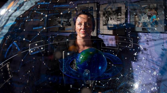 a portrait of Dr. Angela Speck in her office overlaid with a map of the constellations and a globe