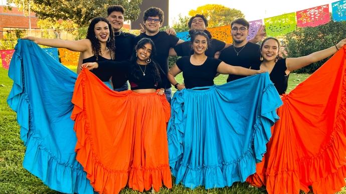 TULA members pose in flamenco skirts before Viva Las Americas