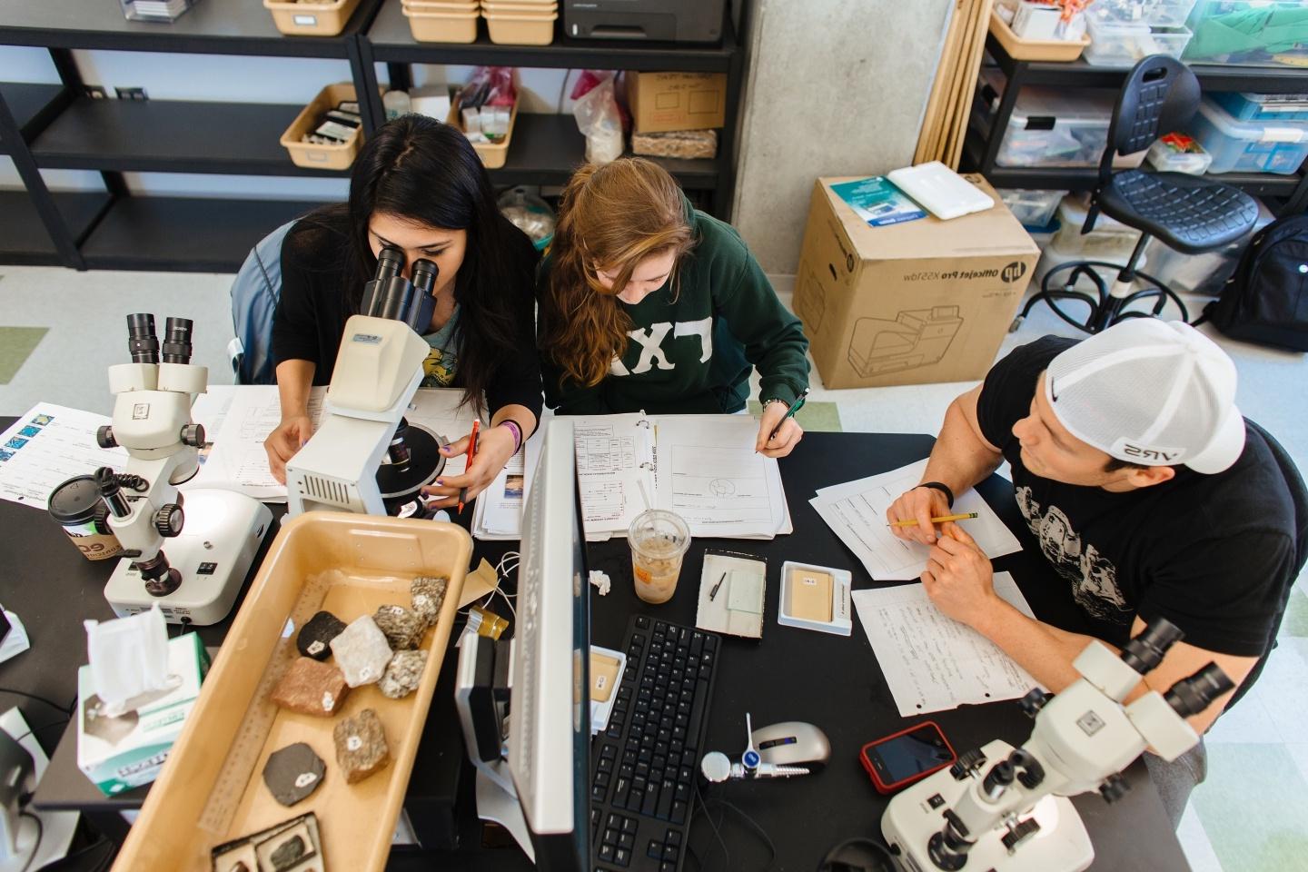 Group of three students in a geology lab