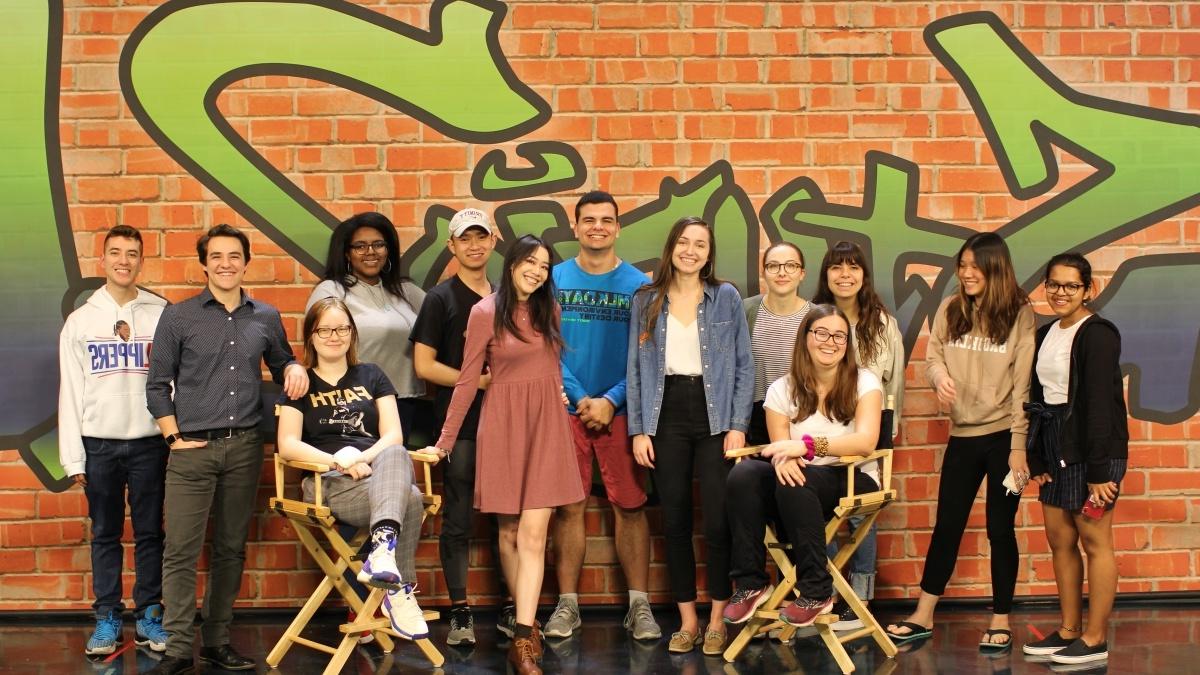 Group of students in front of the Studio 21 wall