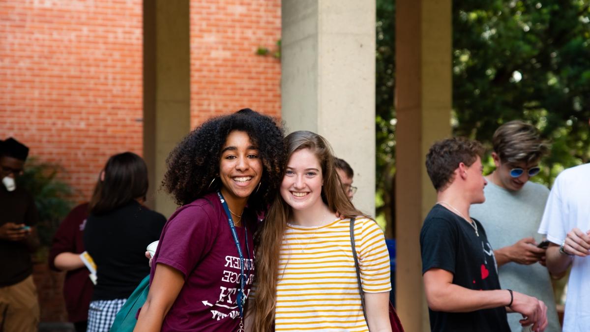 Image of Students smiling outside of tower