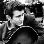 Phil Ochs with guitar black and white photo